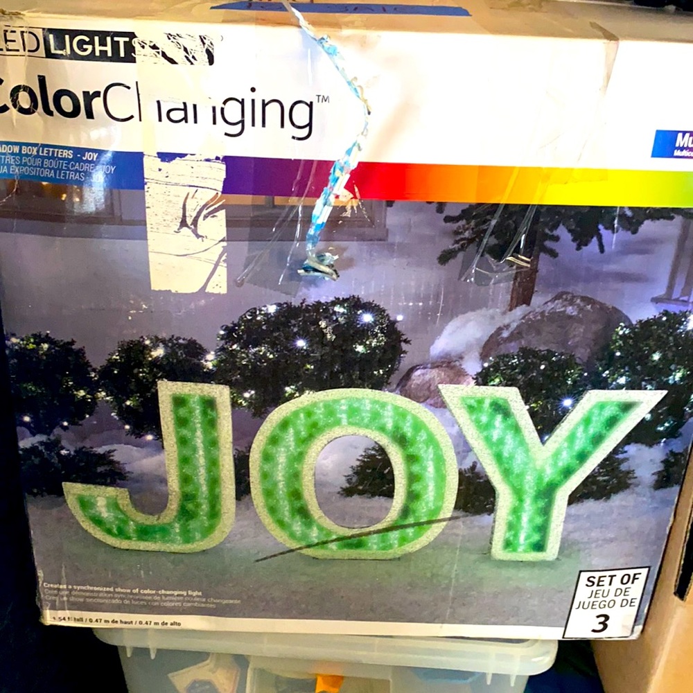 Multi colored changing Xmas Joy sign log